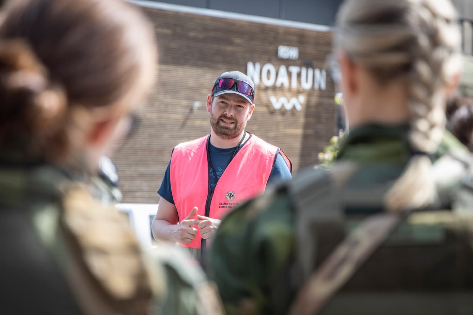 Participants in conversation with event staff at RS Noatun during NMC26